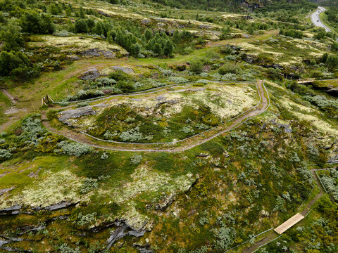 Aerial view of the ancient trapping pit, a relic of the past embraced by the vibrant green of nature, Rondane, Dovre, Innlandet, Norway.
