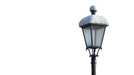 A classic black street lamp, its frosted lantern covered in white snow, stands isolated against a dark transparent background. background removed