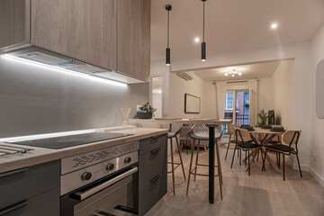 Scandinavian-style kitchen with beech wood cabinets, smooth fronts, and discreet chrome hardware