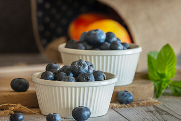 Natural light glides across the smooth surface of the white porcelain and the glistening blueberries, while the white wood acts as a natural diffuser
