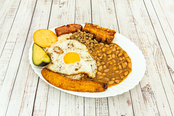 Complete Venezuelan Pabellón Criollo with juicy shredded beef, white rice, refried black beans, and fried plantain slices