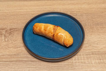 Venezuelan cachito bread with a soft, slightly sweet dough, filled with shredded pork and raisins, served warm.