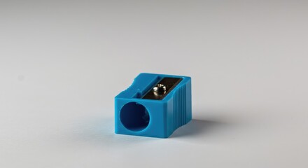 Close up studio shot of a small, colorful, plastic pencil sharpener featuring a metal blade and dual holes, centered and isolated on a pure white surface ,nobody ,cutout ,new