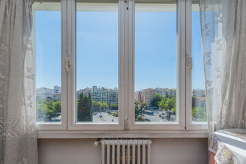 Fototapeta premium room with windows overlooking an urban park