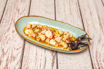 Traditional seafood salad with a mix of cooked seafood, hard-boiled egg, olives, and finely chopped parsley