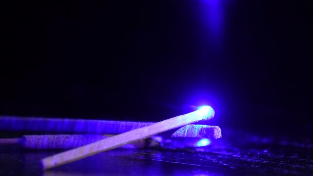 Powerful laser. Dangerous, powerful beam of laser light. Lighting a match.