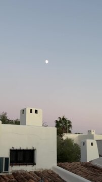 Minimalist white villa exterior against a blue sky at sunset.