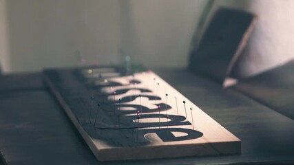 Title: Spray painting wooden sign using stencil