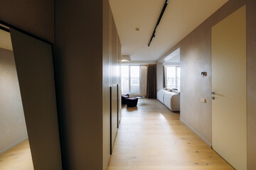 Open corridor leading to living area with freestanding tub
