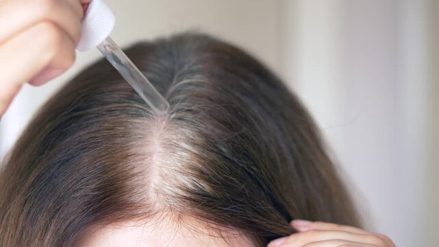 Nourishing vitamin serum applied along the parting to fight gray hair and support healthy follicle function. Vitamin serum massaged into scalp to reduce early gray hair and nourish weak follicles