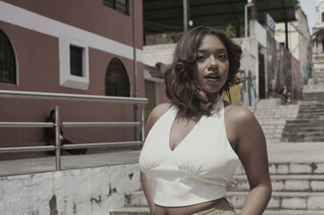 Young woman posing confidently in urban city environment