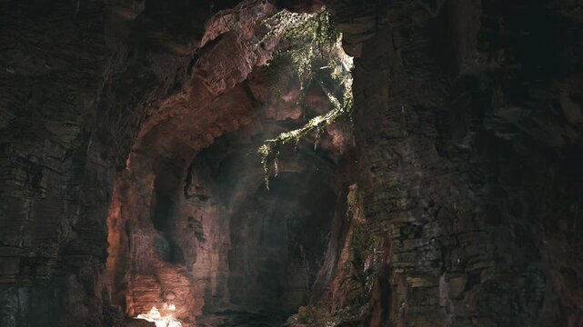 A remarkable underground cave features intricate rock formations illuminated by natural light filtering through an opening. The serene atmosphere invites exploration and wonder.