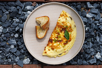 Cheesy Herb Omelette With Toast On A Light Plate For A Cozy Breakfast