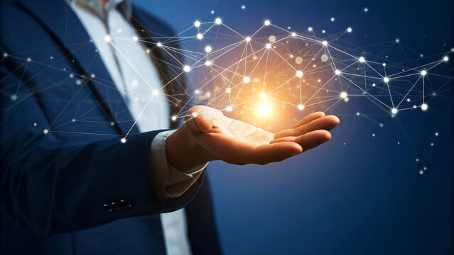 Businessman presenting a virtual network on his hand, symbolizing connection, communication, and technology in the digital age with blue background