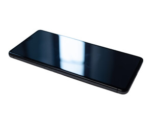 Sleek modern smartphone lying flat on a black surface isolated on transparent background
