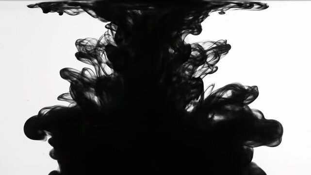 Extreme close-up slow motion footage of deep black ink dispersing and swirling through clear water, creating beautiful, smoky, and unpredictable fractal patterns black, macro, motion