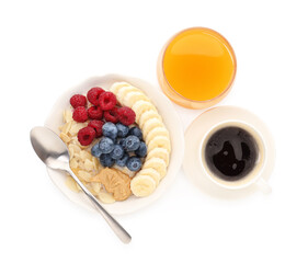 Healthy breakfast. Oatmeal with nuts, banana, berries, coffee and juice isolated on white, top view