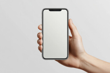 Hand holding a modern smartphone with a blank white screen, mockup. A person's hand holds a smartphone with a clean, empty display, perfect for showcasing apps or designs.