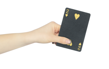 playing card hearts 2 in hand, outstretched hand with black playing card isolated from background