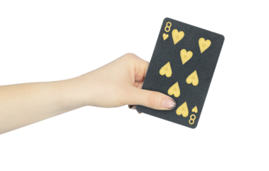 playing card hearts 8 in hand, outstretched hand with black playing card isolated from background