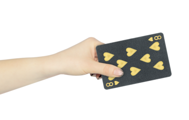playing card hearts 8 in hand, outstretched hand with black playing card isolated from background