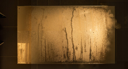 Steam-covered glass table with condensation in modern interior  