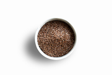 Fresh raw natural organic flax seeds in white bowl on white  background top view. Healthy eating, superfood, eco-friendly brown flax seeds.  stock photo