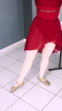 Ballerina performing rond de jambe &agrave; terre en dehors and en dedans beside the barre. Vertical video ideal for dance tutorial, ballet tutorial, dance teaching content and basic ballet practice.