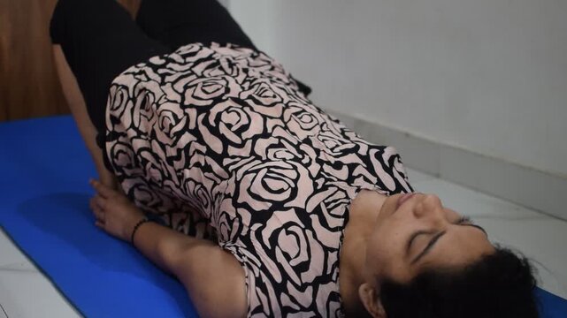 Young Indian woman practicing yoga indoor by online yoga session, Beautiful girl practice basic yoga pose, Asian Indian lady doing indoor yoga