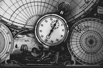 Vintage stopwatch on old nautical map in monochrome