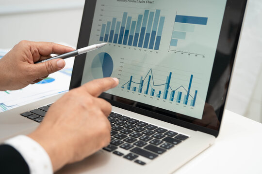 Asian business woman working with financial graph.