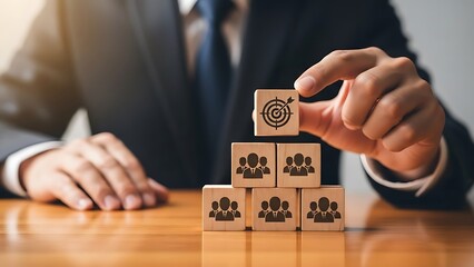 Business strategy and goal achievement businessman building a pyramid of wooden blocks with target and teamwork icons for success
