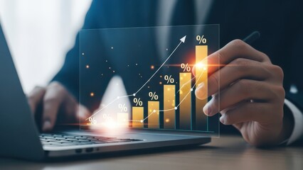 Businessman analyzing financial growth chart on laptop with pen in hand