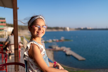 Happy Girl Smiling by Lakeside