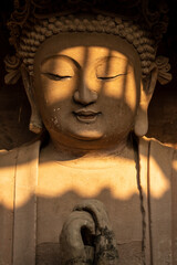 Seated Buddha Statue with Dappled Sunlight at Tapo Cliff Carvings in Anyue China