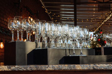 Rows of empty wine and champagne glasses on bar counter - ready for a party