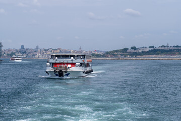 Bosphorus waterway ferry navigating through calm waters with a vibrant city skyline in the...