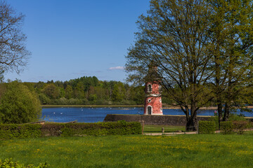 Historical Moritzburg Lighthouse, the only one in inland Saxony, visible behind dense trees and hedges. Idyllic spring scenery