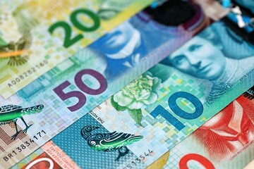 New Zealand dollar money bills in big amount on table close up. Rich life concept in New Zealand. Business and economy