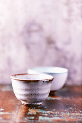 Traditional japanese ceramic on rustic wooden background. Soft focus. Copy space.	