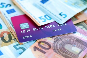 Euro money bills banknotes and credit card for cashless payments. Concept of banking service in European Union countries