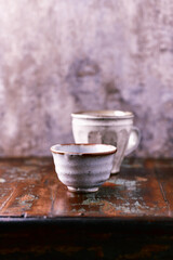 Traditional japanese ceramic on rustic wooden background. Soft focus. Copy space.	