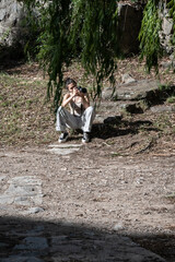 Fototapeta premium Girl taking a photograph in nature while sitting on the floor.