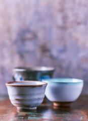 Traditional japanese ceramic on rustic wooden background. Soft focus. Copy space.	