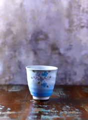 Traditional japanese ceramic on rustic wooden background. Soft focus. Copy space.	