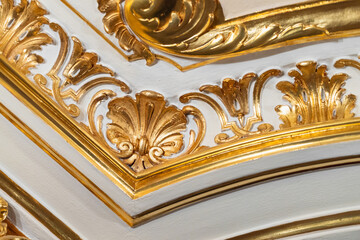 Luxurious ceiling corner ornament featuring gilded swirling acanthus scrolls