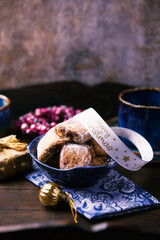 Traditional christmas cookies in a bowl on a rustic wooden background. Soft focus.	