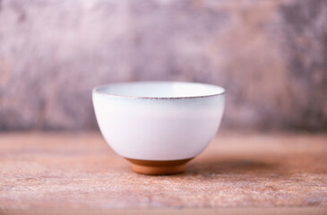 Traditional japanese ceramic on rustic wooden background. Soft focus. Copy space.	