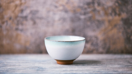 Traditional japanese ceramic on rustic wooden background. Soft focus. Copy space.	