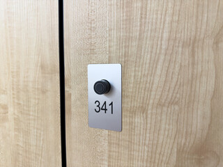 Keyless locker door closing mechanism. Button for applying club bracelet to access personal locker for storing items during sports. Close up photo of locker door at gym